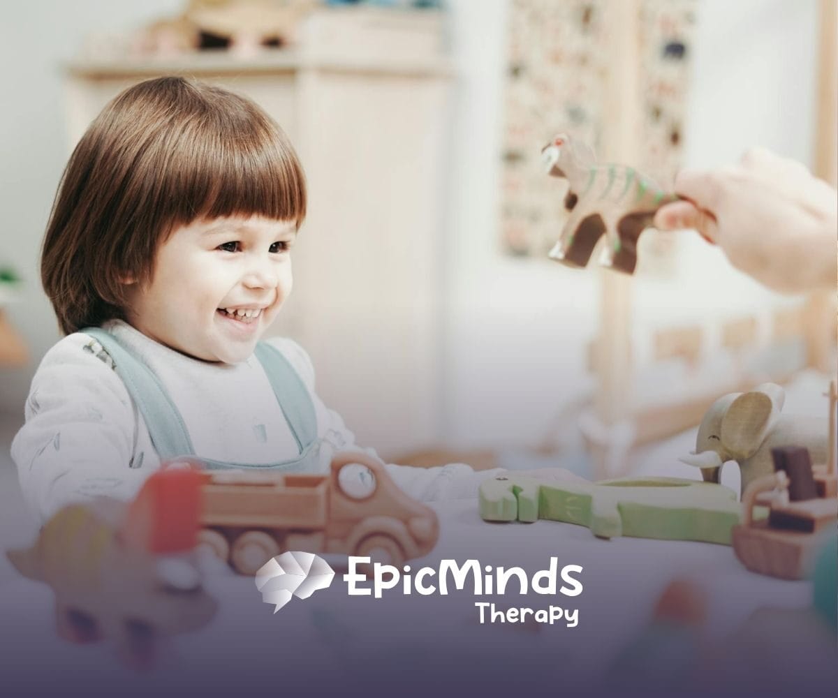 An autistic girl holding and inspecting a wooden toy helicopter at a table during ABA therapy in MD.
