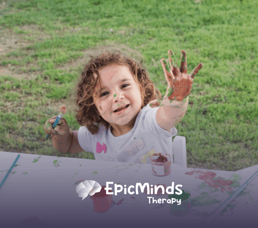 Child enjoying outdoor painting activity during ABA therapy.