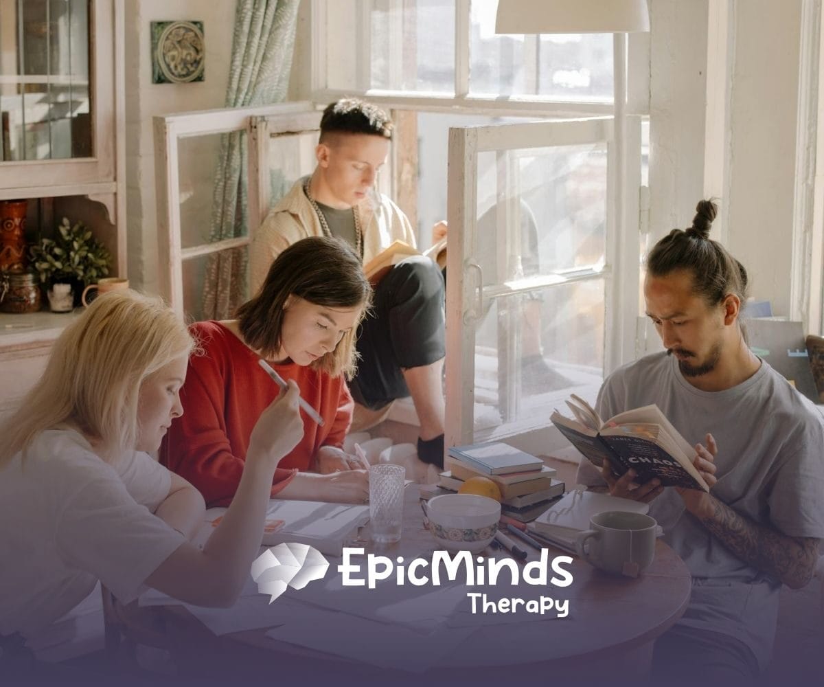 BCBA student in library looking tired while studying, surrounded by open books and a lamp in MD.