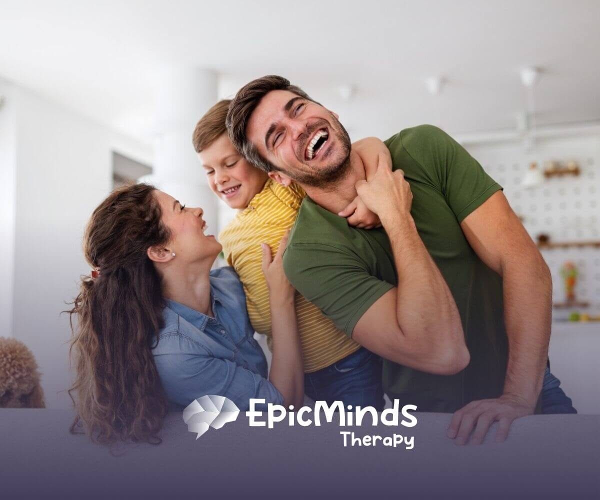 Happy family laughing together on a couch with their dog nearby.