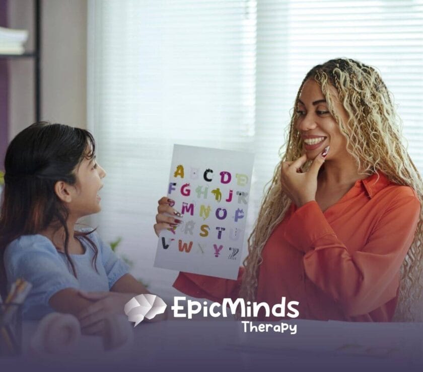 ABA therapist teaches a child the alphabet using colorful flashcards in a bright classroom in ABA therapy.