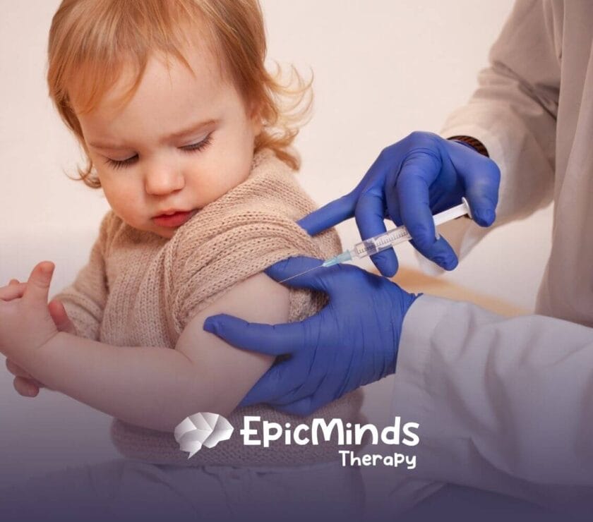 A toddler with autism receiving a vaccine shot in the upper arm.