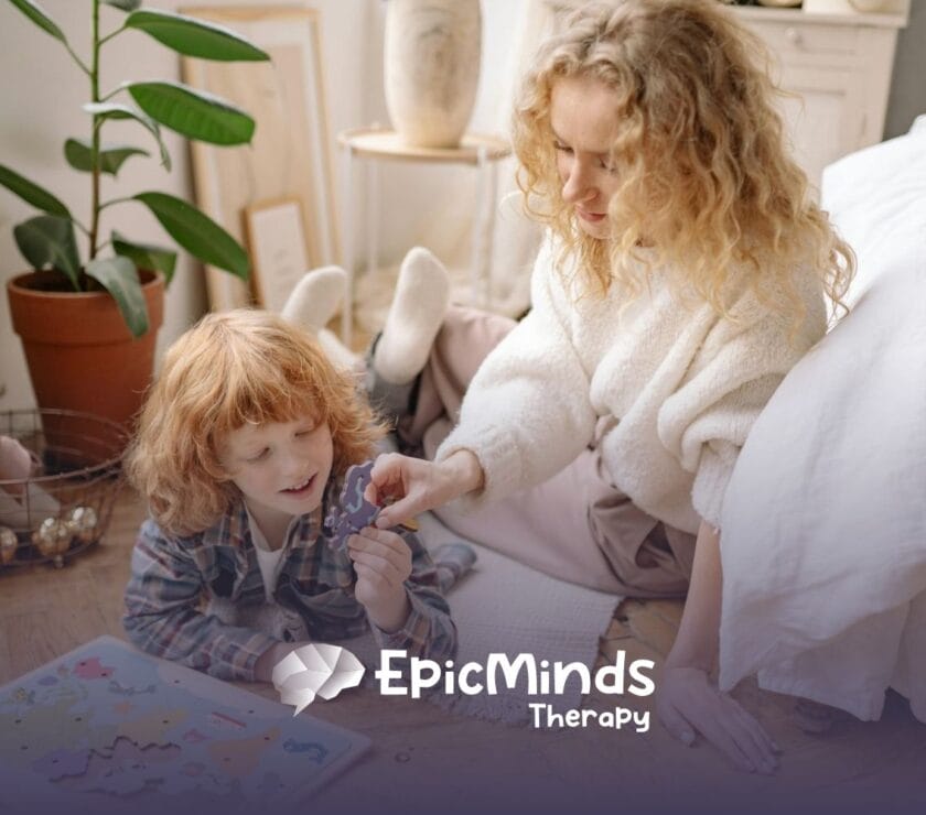 An ABA therapist and autistic child doing a world map puzzle on the floor together during in-home ABA therapy in NC.