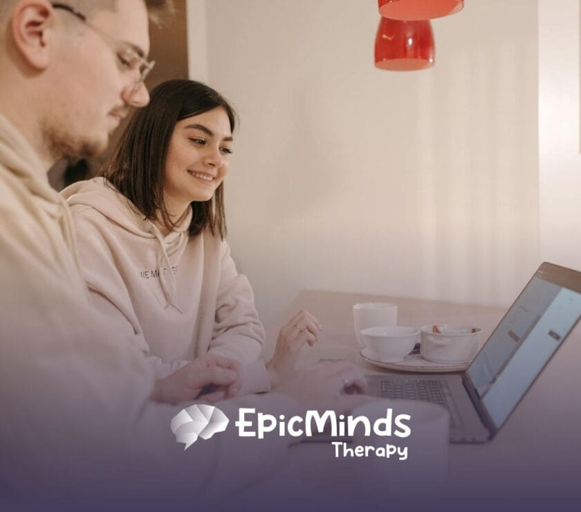 An RBT and RBT supervisor smiling while explaining the RBT supervision requirements at a laptop in North Carolina.