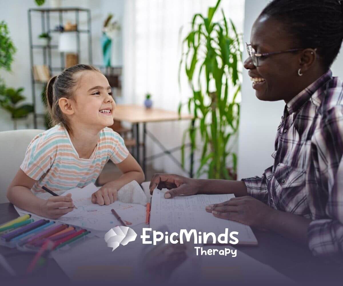 BCBA and autistic child laughing together during an activity in ABA therapy.
