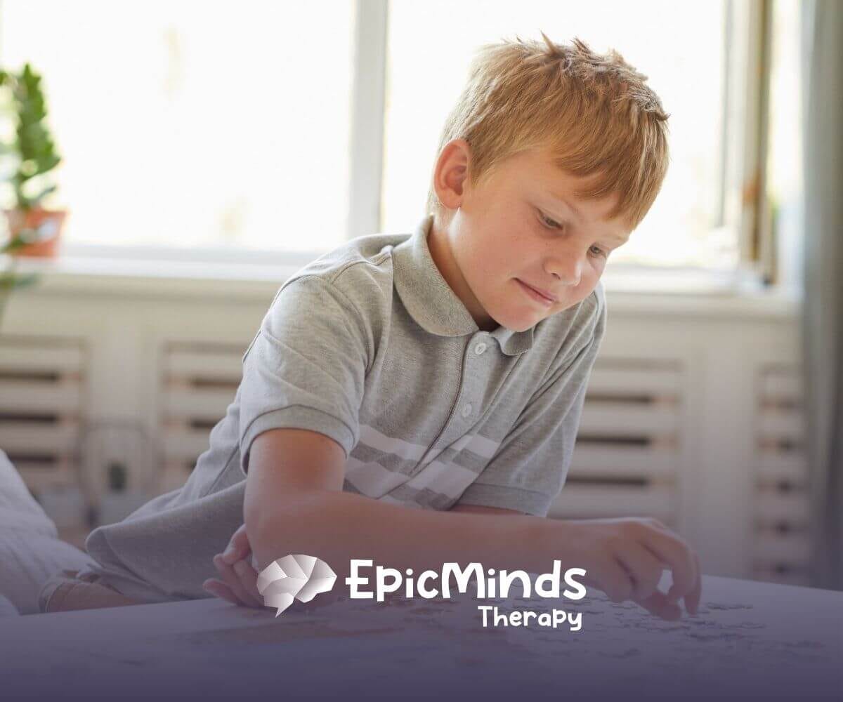 Boy with autism solving a puzzle at home during an educational activity.
