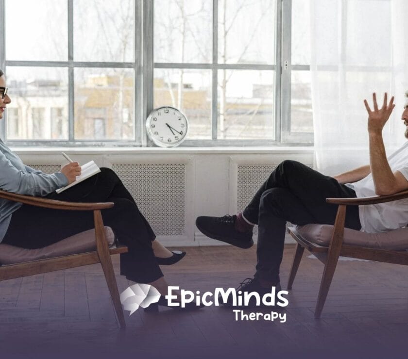 ABA Manager man speaks with a female therapist in a sunlit office during a counseling session in North Carolina.