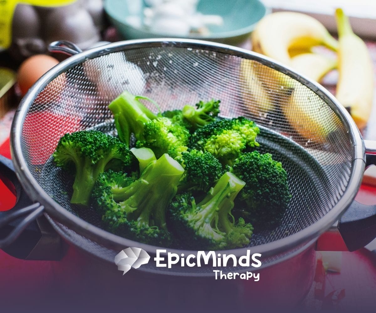 Freshly steamed broccoli, containing sulfrophane, is placed in a metal strainer on a kitchen counter in NC.