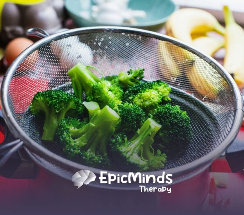 Freshly steamed broccoli, containing sulfrophane, is placed in a metal strainer on a kitchen counter in NC.