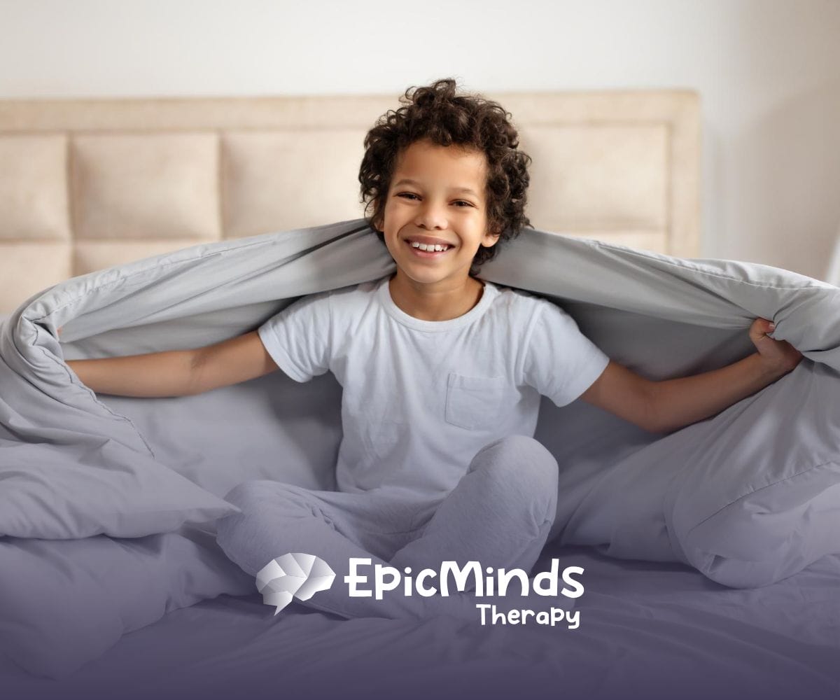 A kid on a bed with a comforter blanket