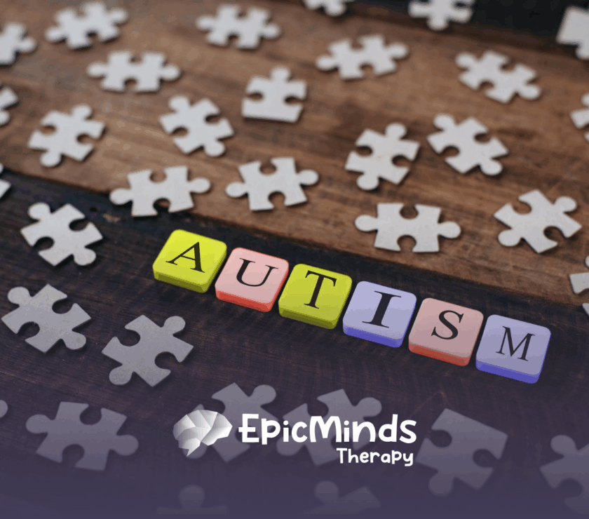 Colorful blocks spelling the word "autism" with puzzle peices around it